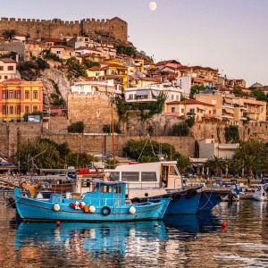 shutterstock_1503569339-Fishing boats in port and old town houses under moon light at sunset, Panagia, Kavala.jpg